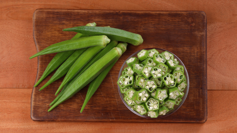 fresh okra on a wooden board