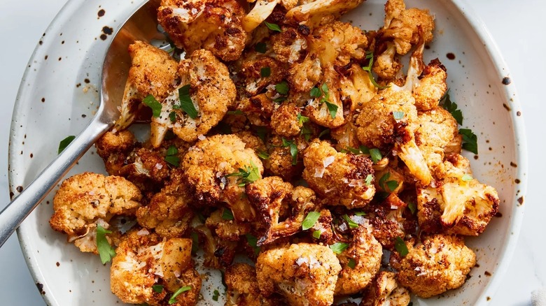 air fried cauliflower in dish with spoon