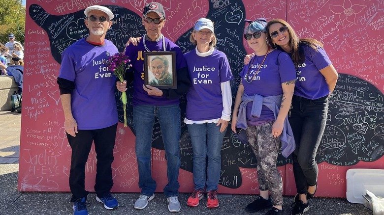 Group of five people in purple "justice for Evan" shirts