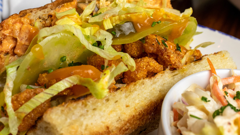 Green tomato and crispy shrimp po'boy sandwich with coleslaw