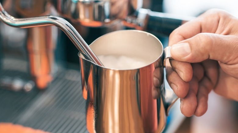 A milk steamer in action