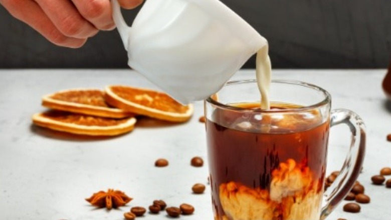 Heavy cream poured into coffee