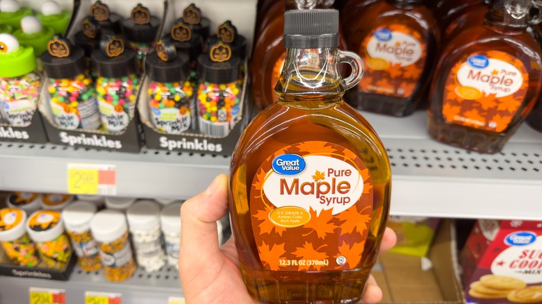 Person holding maple syrup container