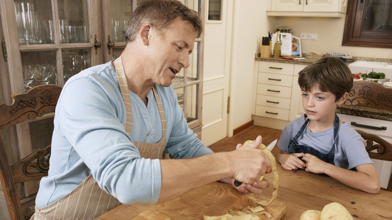 A father and son prepping potatoes