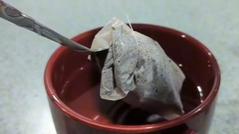 Tea bag with spoon and cup