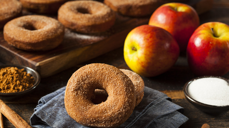 Apple cider donuts beside real apples