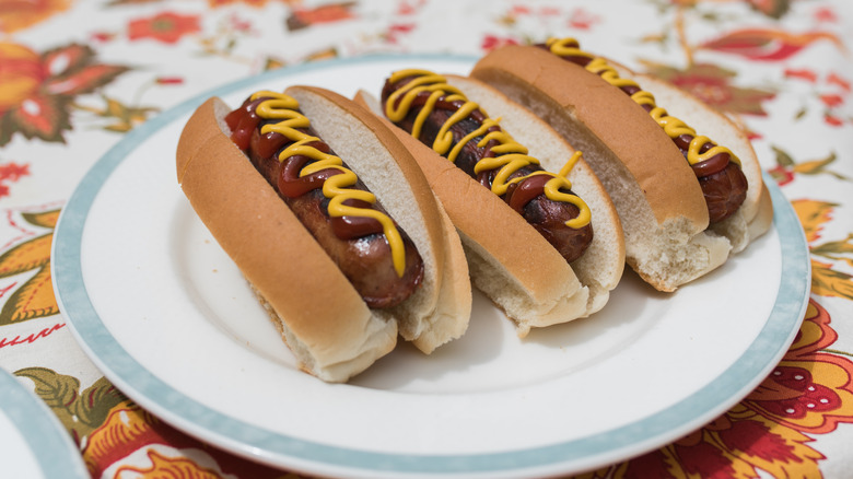 Three hot dogs in split-top buns