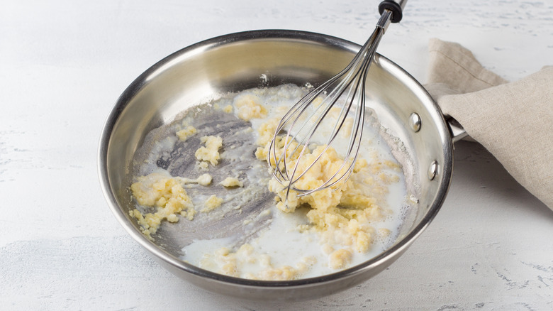 whisking bechamel in skillet