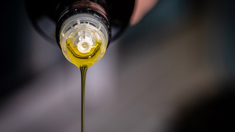 pouring olive oil close up