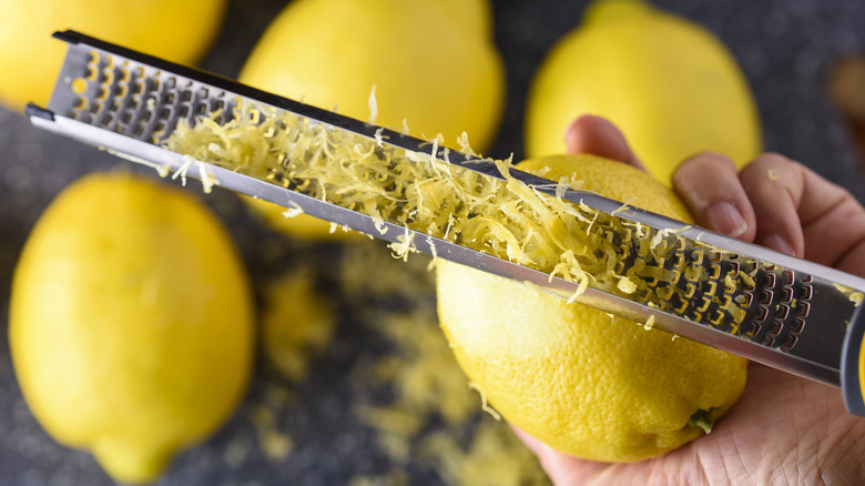 person zesting lemon