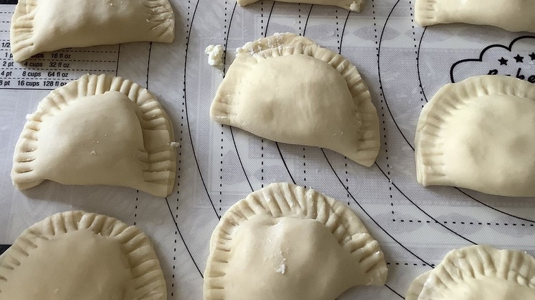 Fork-sealed pierogi on table