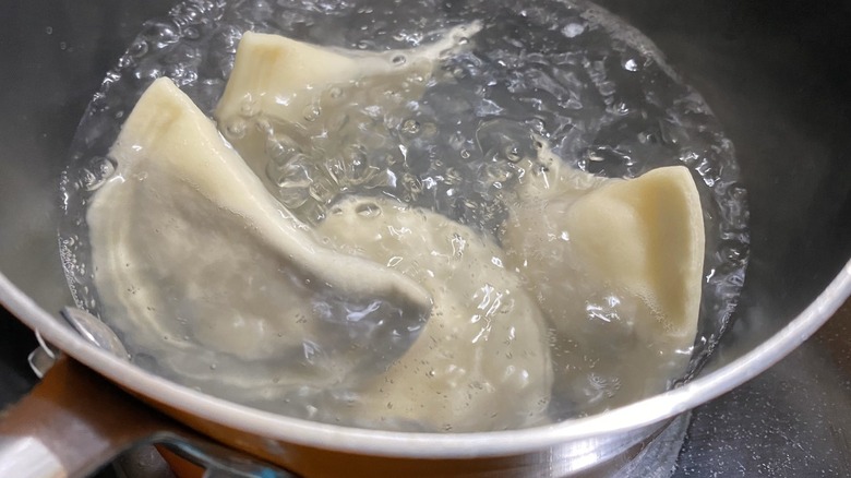 Pierogi boiling in pot