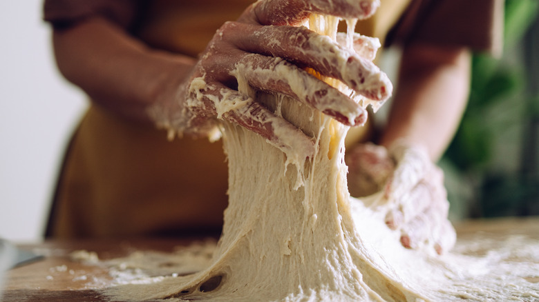 Sticky dough on woman's hands