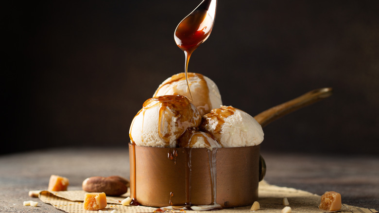 caramel sauce being drizzled over ice cream