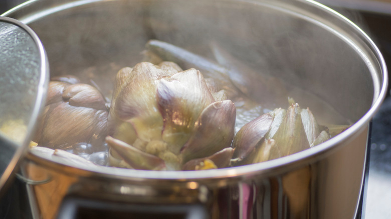 steaming artichoke in large pot