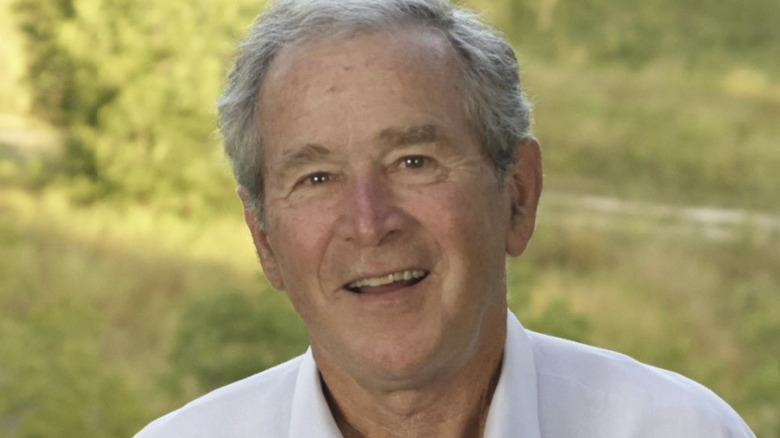 George W. Bush poses outdoors