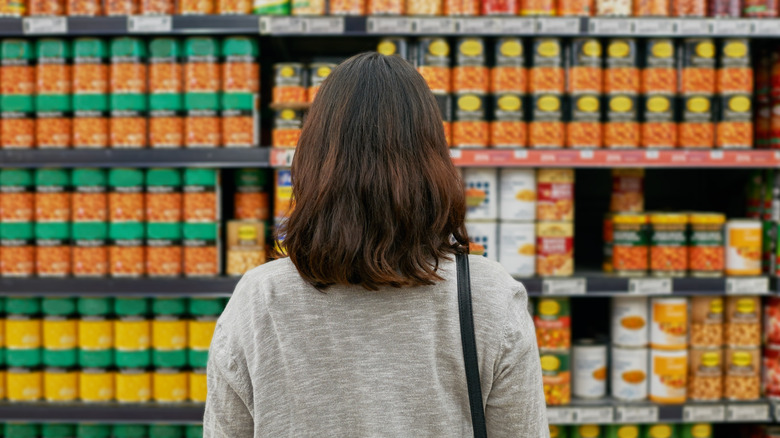 woman shopping for canned food