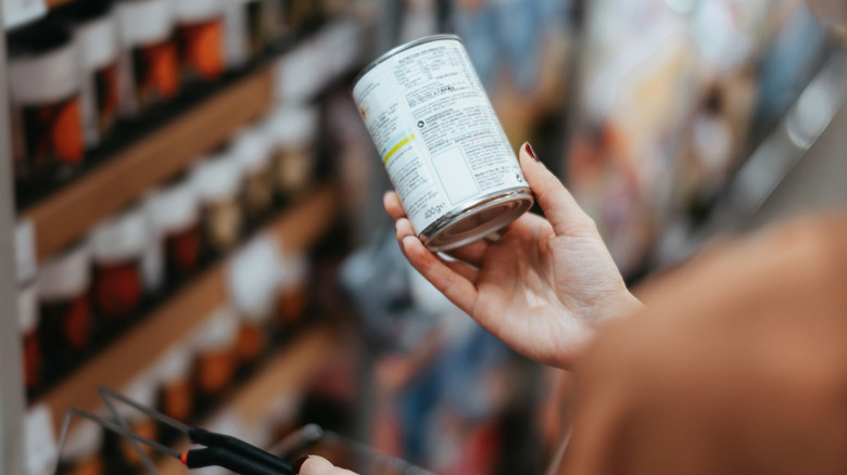 shopper checking canned food label