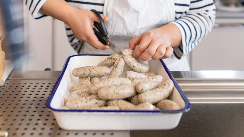 Cutting sausages with scissors