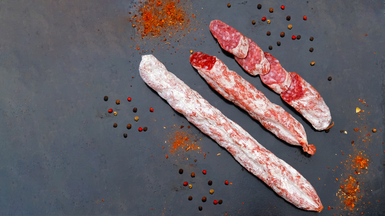 Salami on slate background