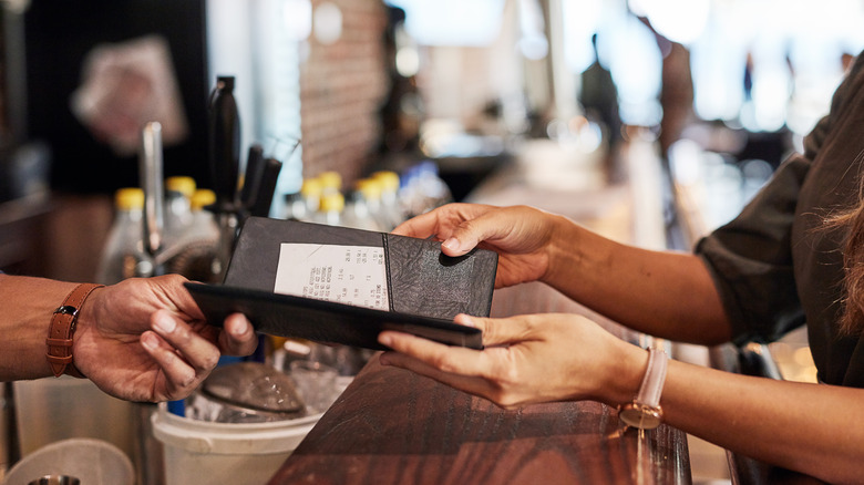 handing over a check restaurant