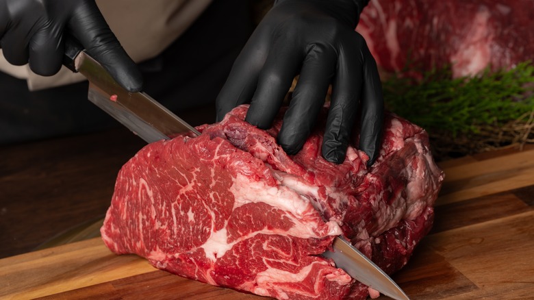 butcher cutting steak