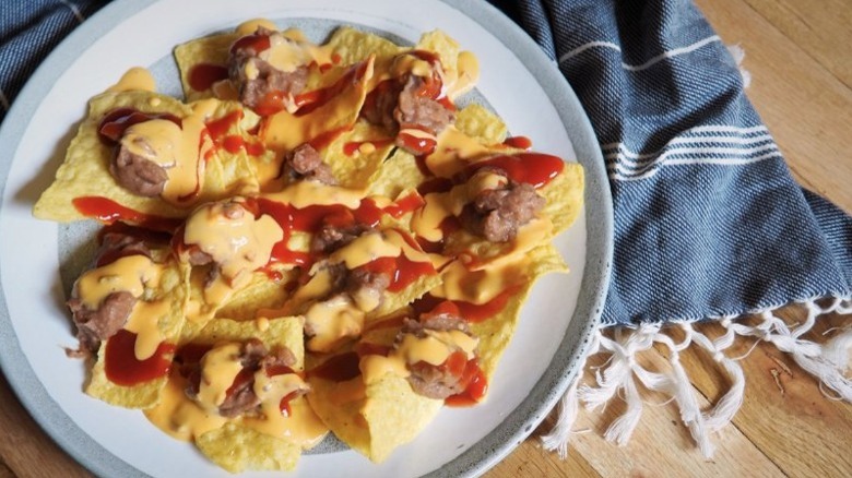 nachos with refried beans and cheese sauce