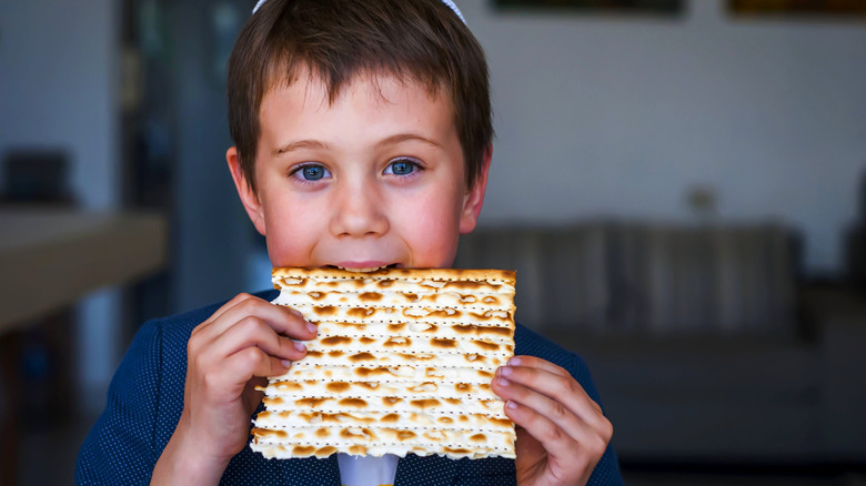 Child eating a piece of matzo