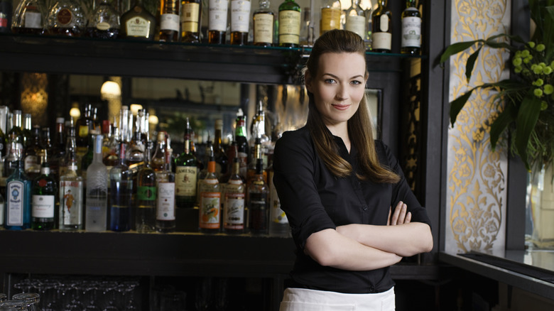 woman bartender behind bar