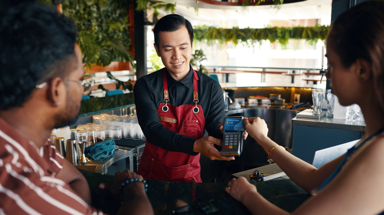 bartender helping customers