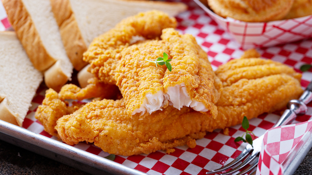 fried catfish in basket with white bread