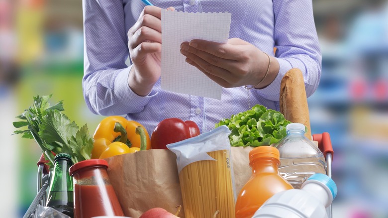 lady checking items off shopping list