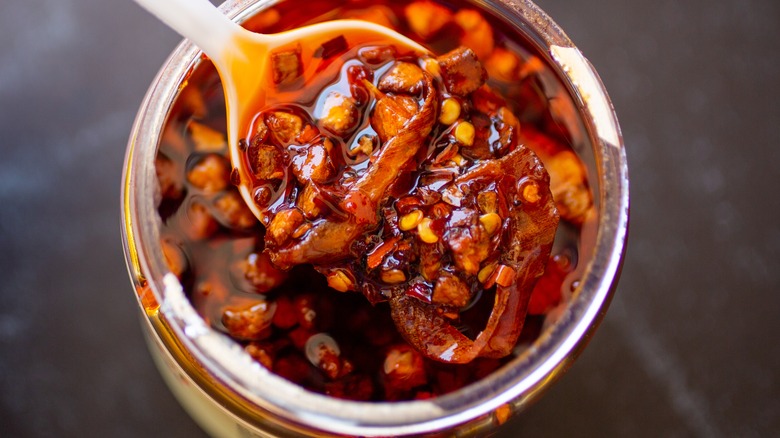 chili oil in jar with spoon