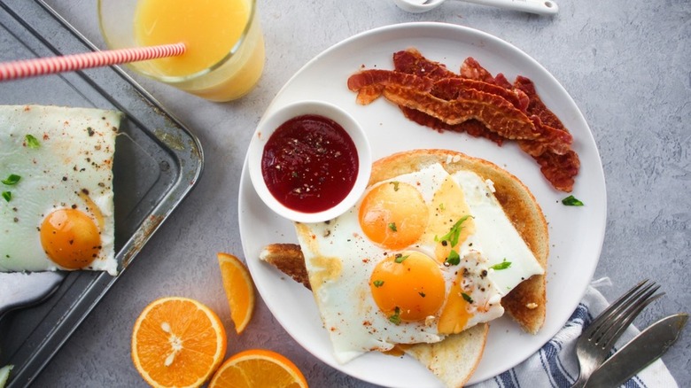 sheet pan eggs with orange juice, toast, and bacon
