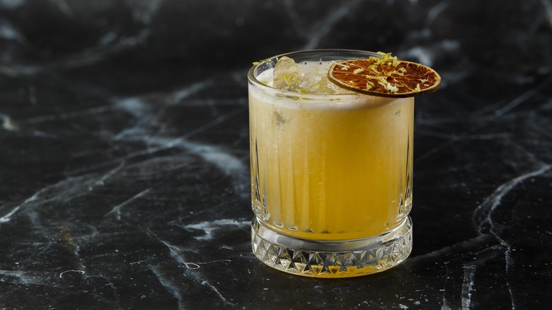 A fancily-presented mescal drink on a slab of marble