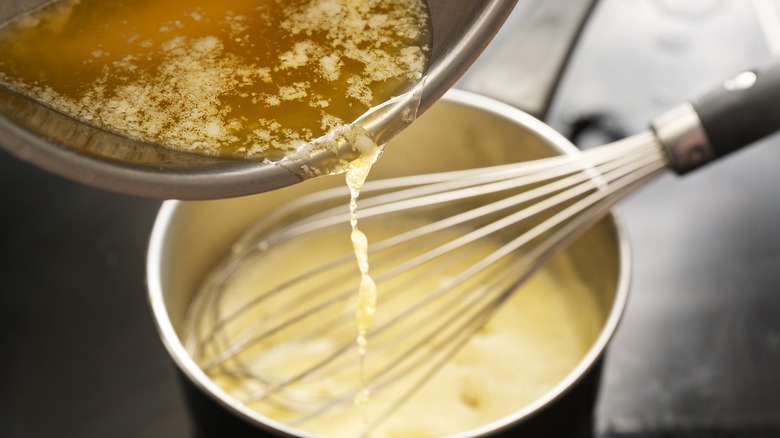 Adding butter to hollandaise sauce