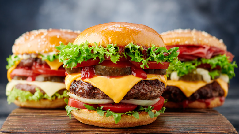 Three hamburgers on a board