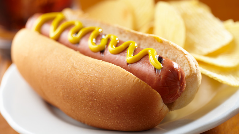 Hot dog topped with mustard