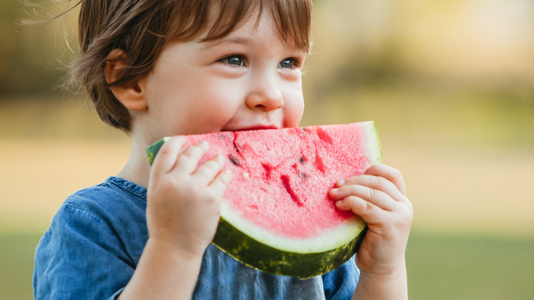 Kid eating watermelon