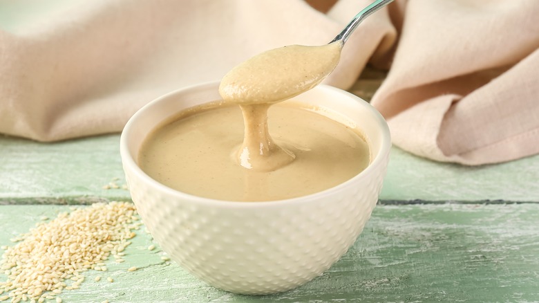 Bowl of tahini on wooden table