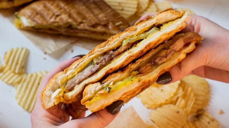 Holding Cuban sandwich