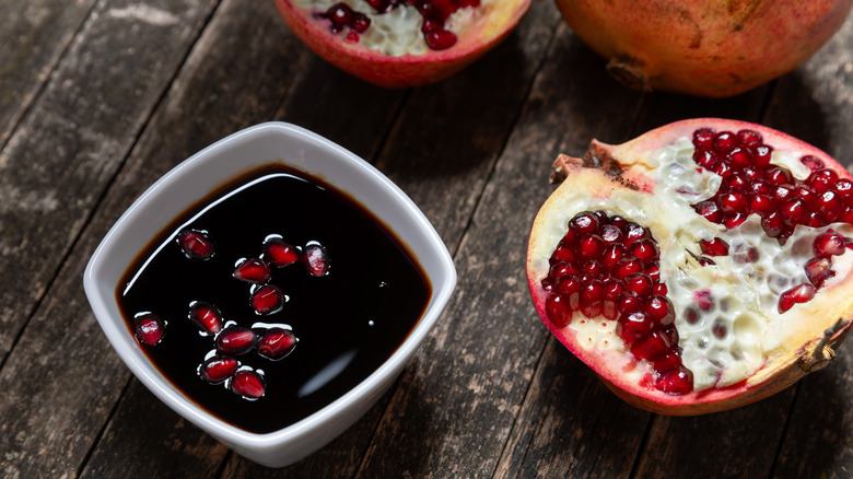 Bowl of pomegranate molasses and fresh pomegranate