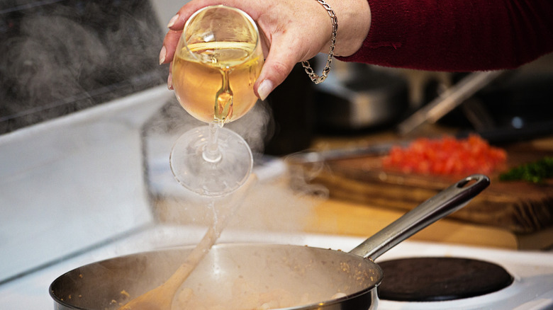 pouring wine into pan