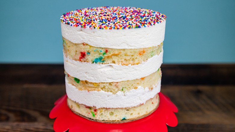 A layered confetti cake with sprinkles