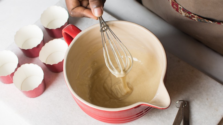 A hand whisking cake batter