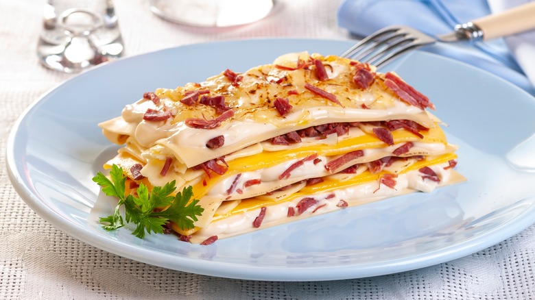 lasagna with chopped bacon on plate