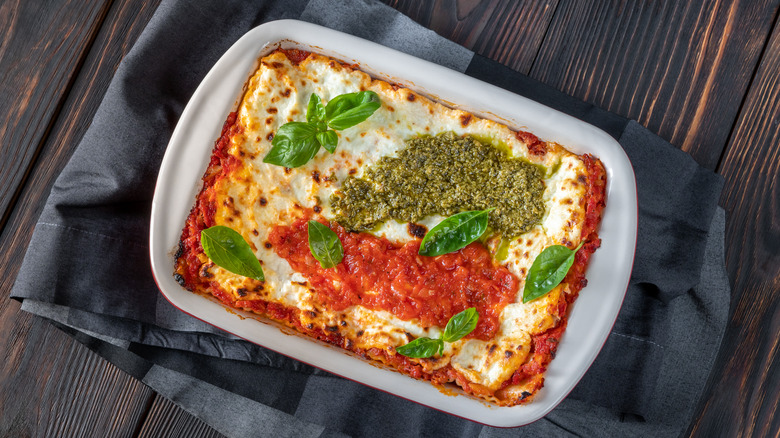 basil pesto lasagna in casserole dish on table