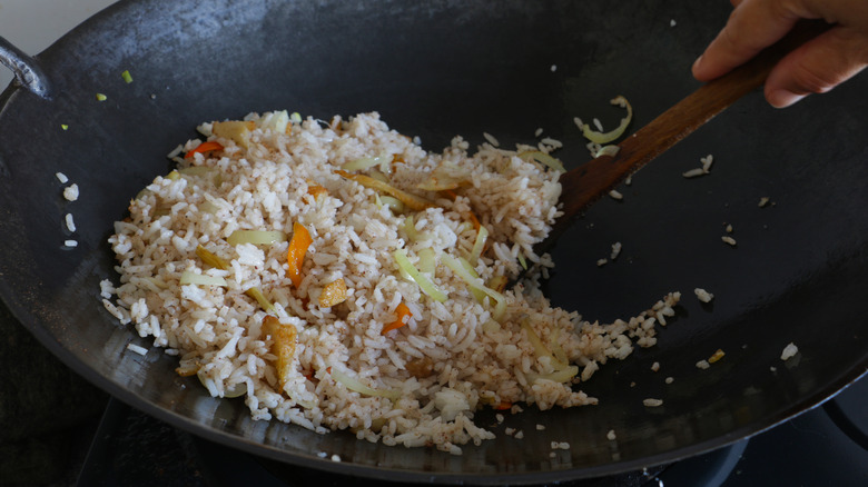 wok of fried rice with vegetables