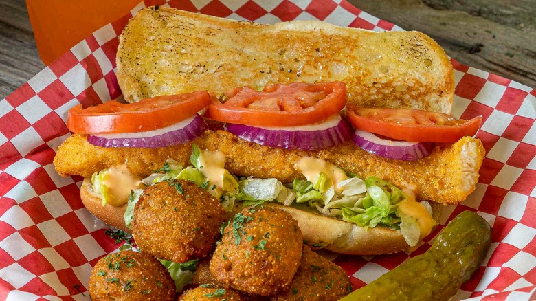 loaded po'boy on plate with garnishes