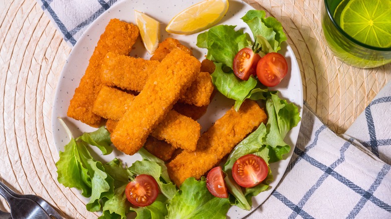 fish sticks on a plate with green salad